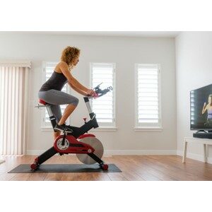 Women Riding Bike Watching TV